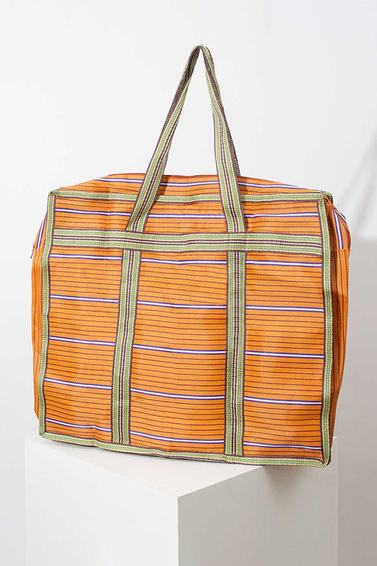  100% S3  The XL Market Tote is a very large, square tote with short shoulder straps. It is made of upcycled nylon with a striped pattern. The bag pictured is orange and green, but the fabric varies by bag. The bag has a zip closure.       	 The XL Market Tote is a very large, square tote with short shoulder straps. It is made of upcycled nylon with a striped pattern. The bag pictured is orange and green, but the fabric varies by bag. The bag has a zip closure. 
