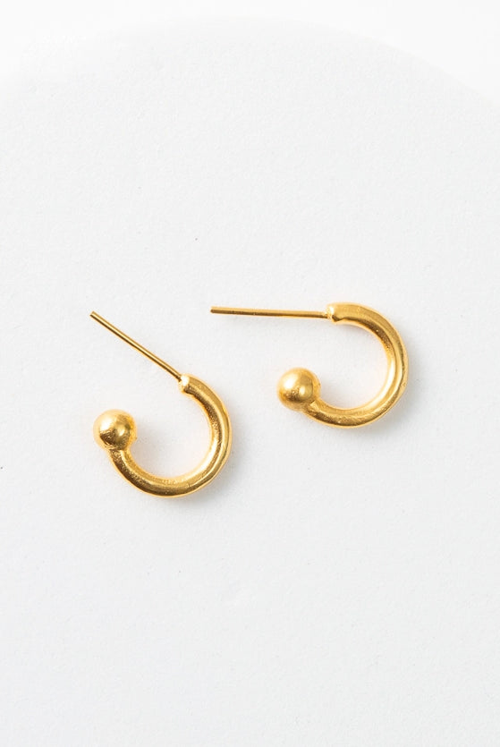 The Convertible Heart Huggies are shown with the heart charm removed, giving them a simple gold hoop look.