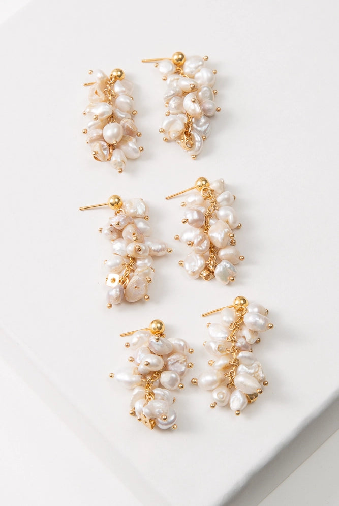 Three pairs of Convertible Pearl Cluster Earrings are shown. Due to the organic nature of the materials used, the pearls on each pair varies slightly in shape and color.
