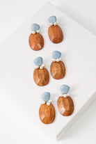 Three pairs of the Salinas Earrings are shown. Due to the natural materials used, the shade and striations of the wood varies slightly between each pair.