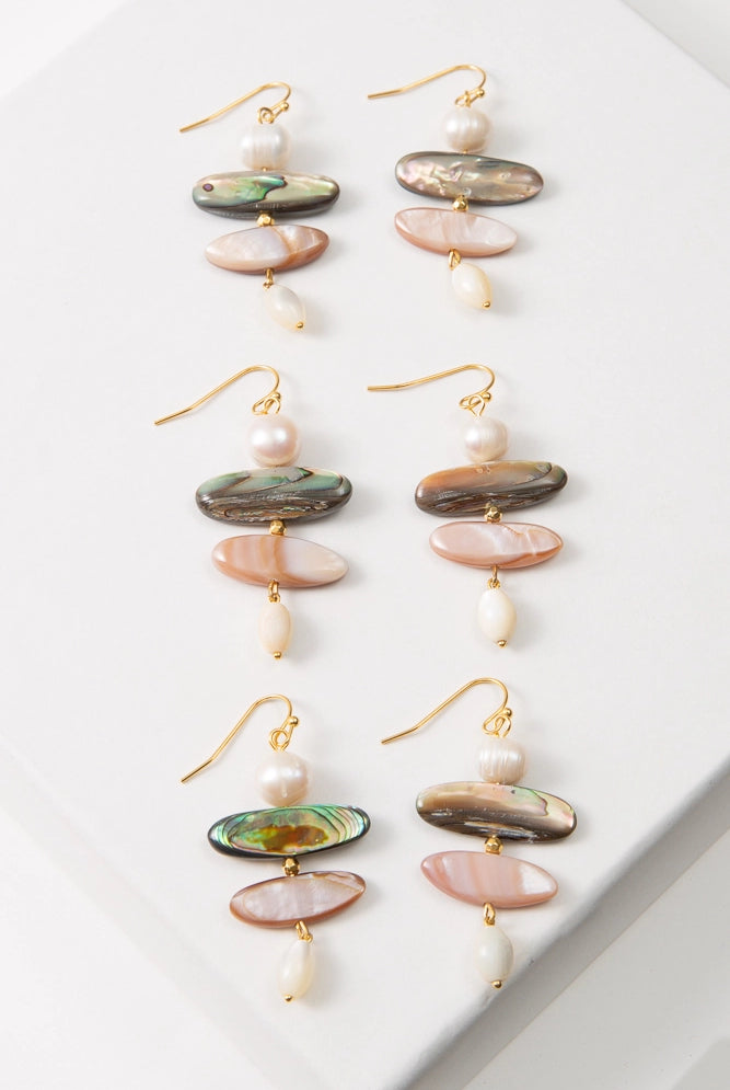 Three pairs of Shell Trove Earrings are shown. Due to the natural materials used, the colors and markings of the shell pieces in each pair vary slightly.
