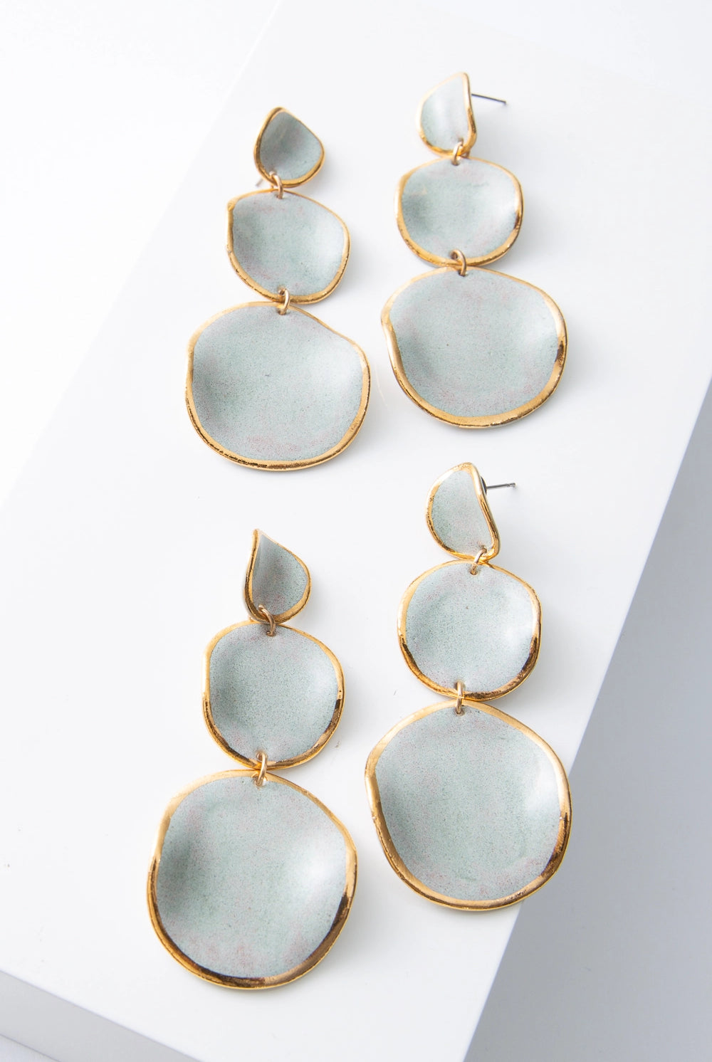 Two pairs of Stacked Spheres Earrings are shown next to each other, demonstrating the slight variations in shape and color that can occur due to the handmade nature of the materials.