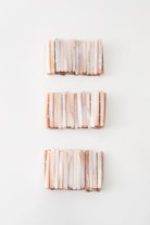 Three Beachcomber Bracelets are pictured. Due to the natural shell used, each varies slightly in shade. However, all have peach and white tones.