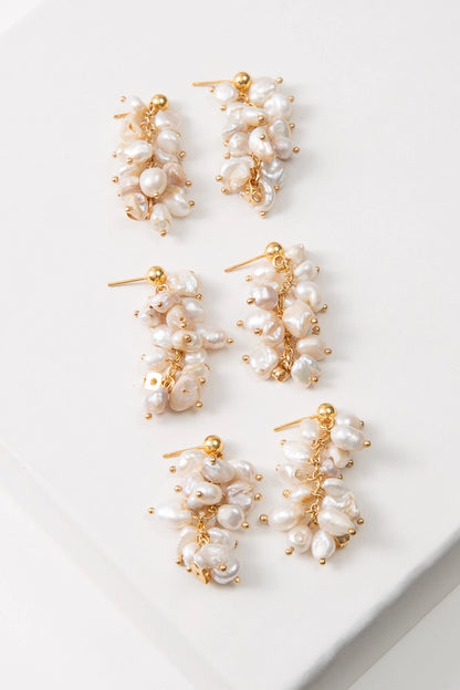 Three pairs of Convertible Pearl Cluster Earrings are shown. Due to the organic nature of the materials used, the pearls on each pair varies slightly in shape and color.