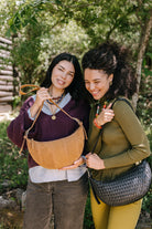 Crescent Sling Woven Leather Noir - HANDBAGS