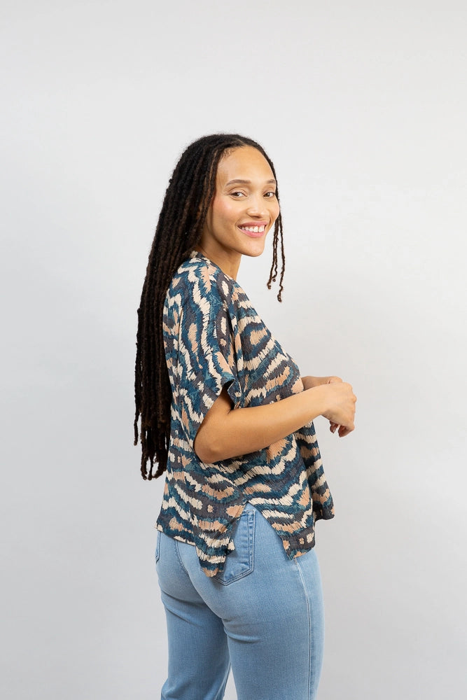 The Oversized Boxy Top is worn untucked. It hits a few inches below the waist and has a split at the bottom of each side, giving the top a flowier feel.