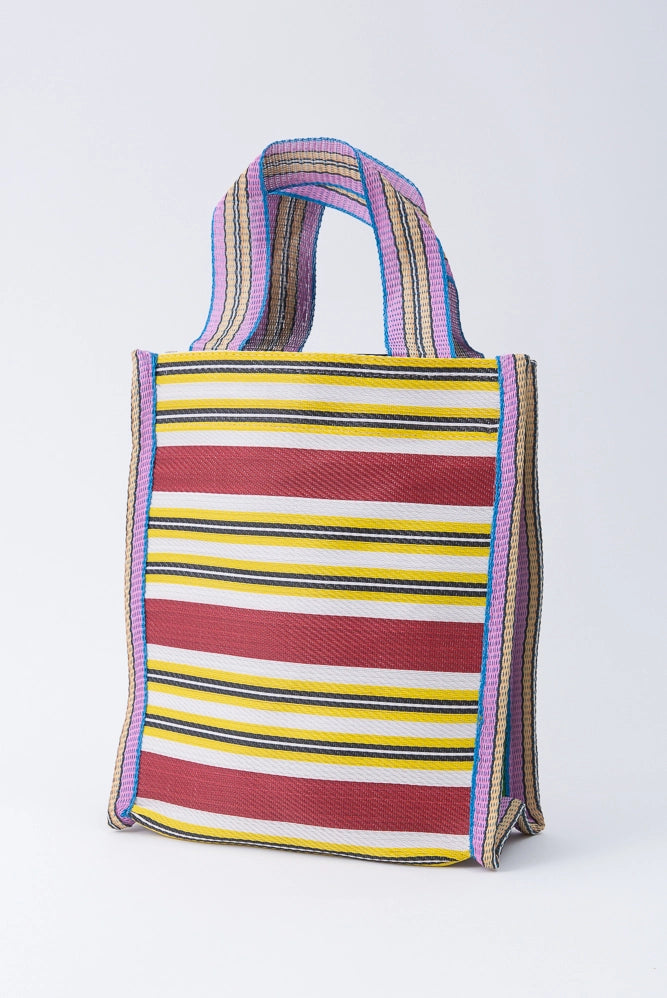 One example of an Eco Gift Sack is pictured. It is a rectangular bag that is taller than it is wide. The bag is composed of yellow, white and red striped nylon fabric. The bag has two short handles composed of a contrasting striped nylon.