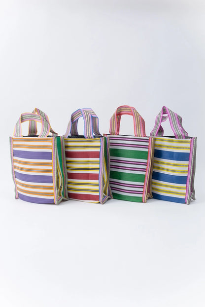 Four Eco Gift Sacks are pictured. Each is the same size, shape, and pattern, but the color palette of the stripes varies on each bag. 