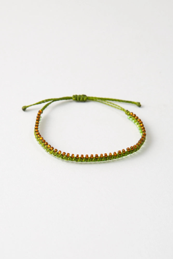 The Amiga colorway features lime green thread with amber and light green glass bead accents.