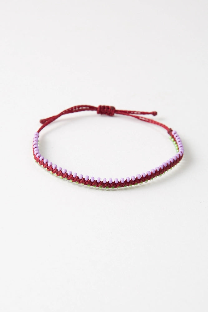 The Chica colorway features crimson thread with pink and light green glass bead accents.