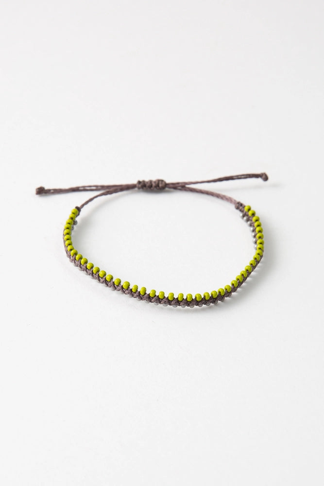 The Compadre colorway features olive thread with lime green and silver glass bead accents.