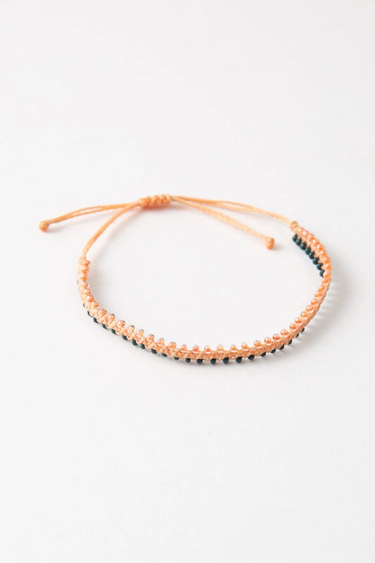 The Gal Pal colorway features peach thread with peach and dark green glass bead accents.