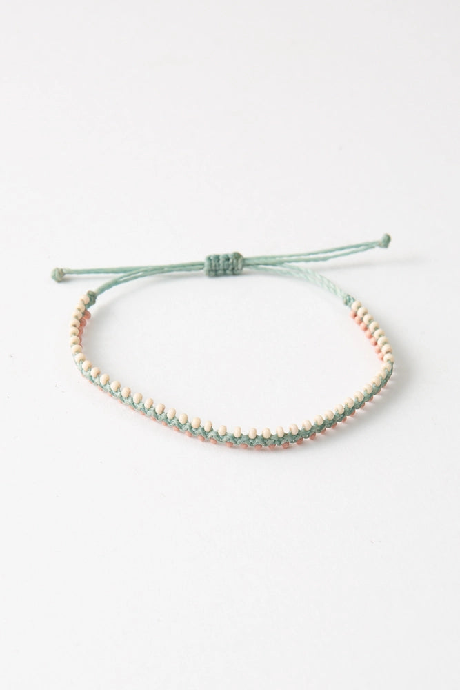 The Sister colorway features mint thread with white and peach glass bead accents.