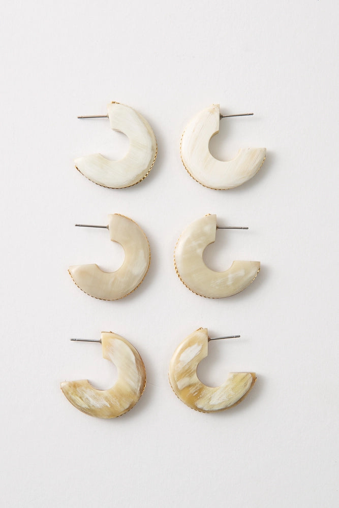 Three pairs of Fusion Hoops are pictured, showing the natural horn variations between each pair. Some are pure white, while others have more caramel variations.