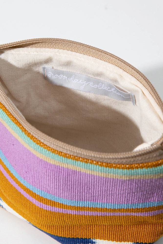 The interior of the Wander Pouch is shown. It is lined with cream colored cotton fabric and has no interior pockets.