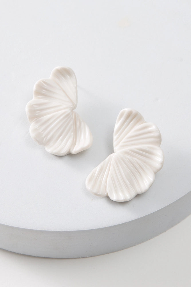 The Porcelain Petal Earrings are post-style earrings composed of white porcelain. The earrings feature several porcelain petals that overlap and fan out to create a half-moon shape.