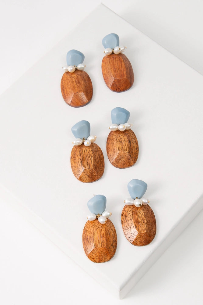 Three pairs of the Salinas Earrings are shown. Due to the natural materials used, the shade and striations of the wood varies slightly between each pair.