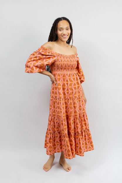 The Smocked Maxi Dress is shown with the elastic neckline pulled down over a model's shoulders for an off-the-shoulder look.