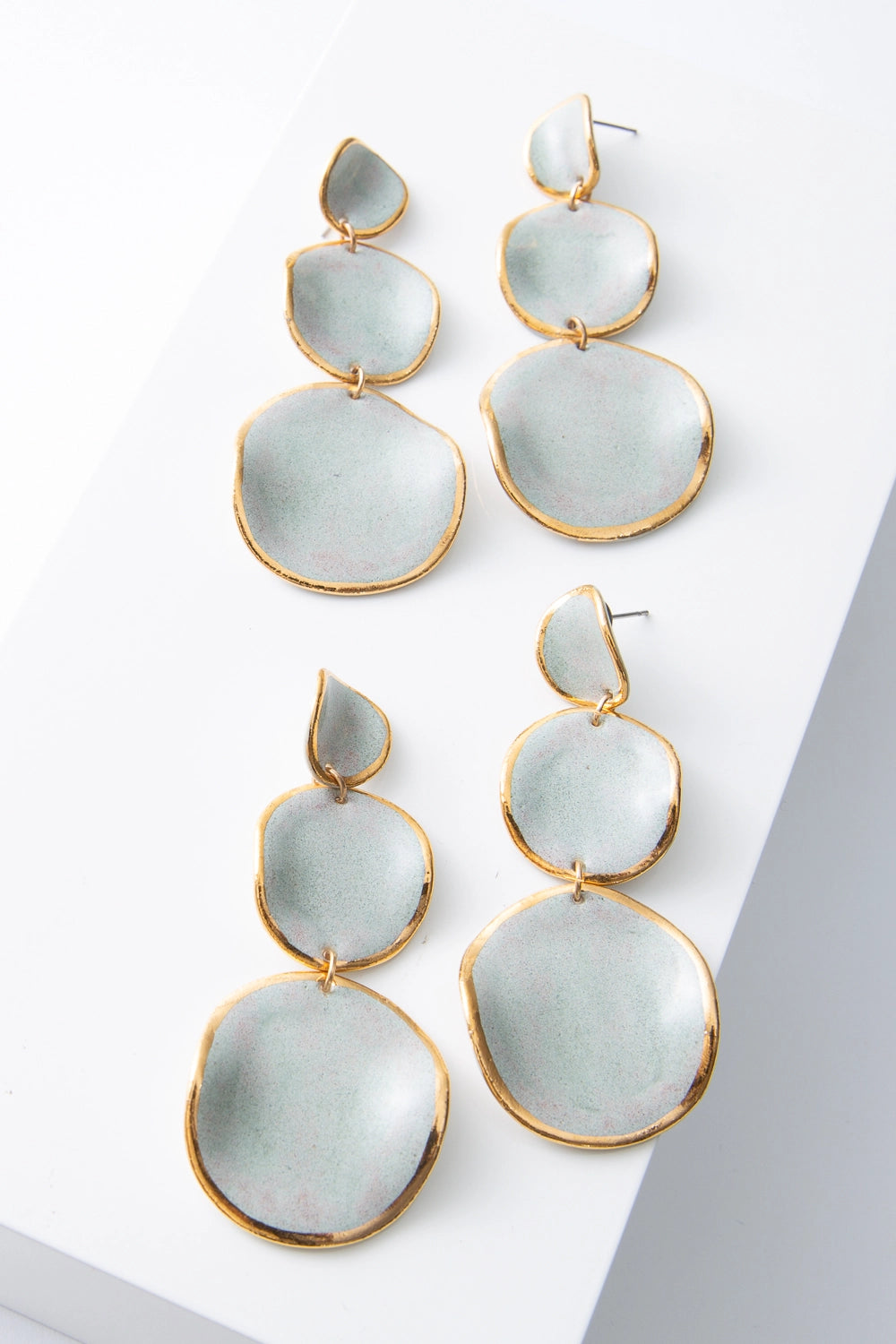 Two pairs of Stacked Spheres Earrings are shown next to each other, demonstrating the slight variations in shape and color that can occur due to the handmade nature of the materials.