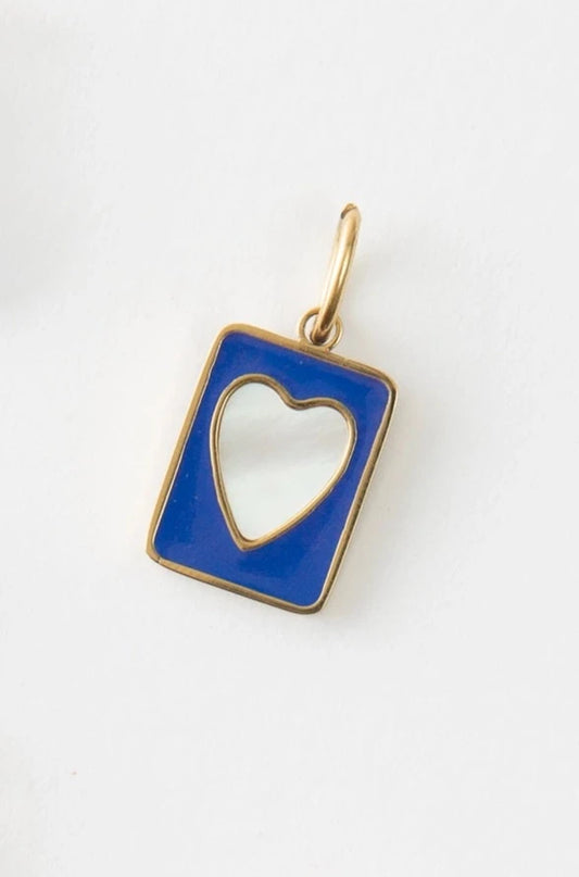 The Trust Charm is a rectangular charm composed of blue enamel. There is a heart-shaped cut-out in the center. The charm is outlined in gold and hangs from a gold ring.